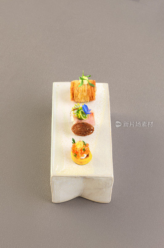 Elegant Canapé Appetizer Amuse Bouche food with salmon, caviar and ham in Michelin Star Restaurant